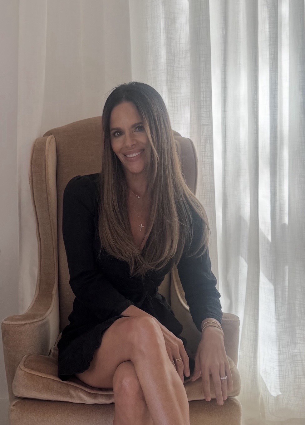 Lorri Brunacini Jones seated in a wingback armchair