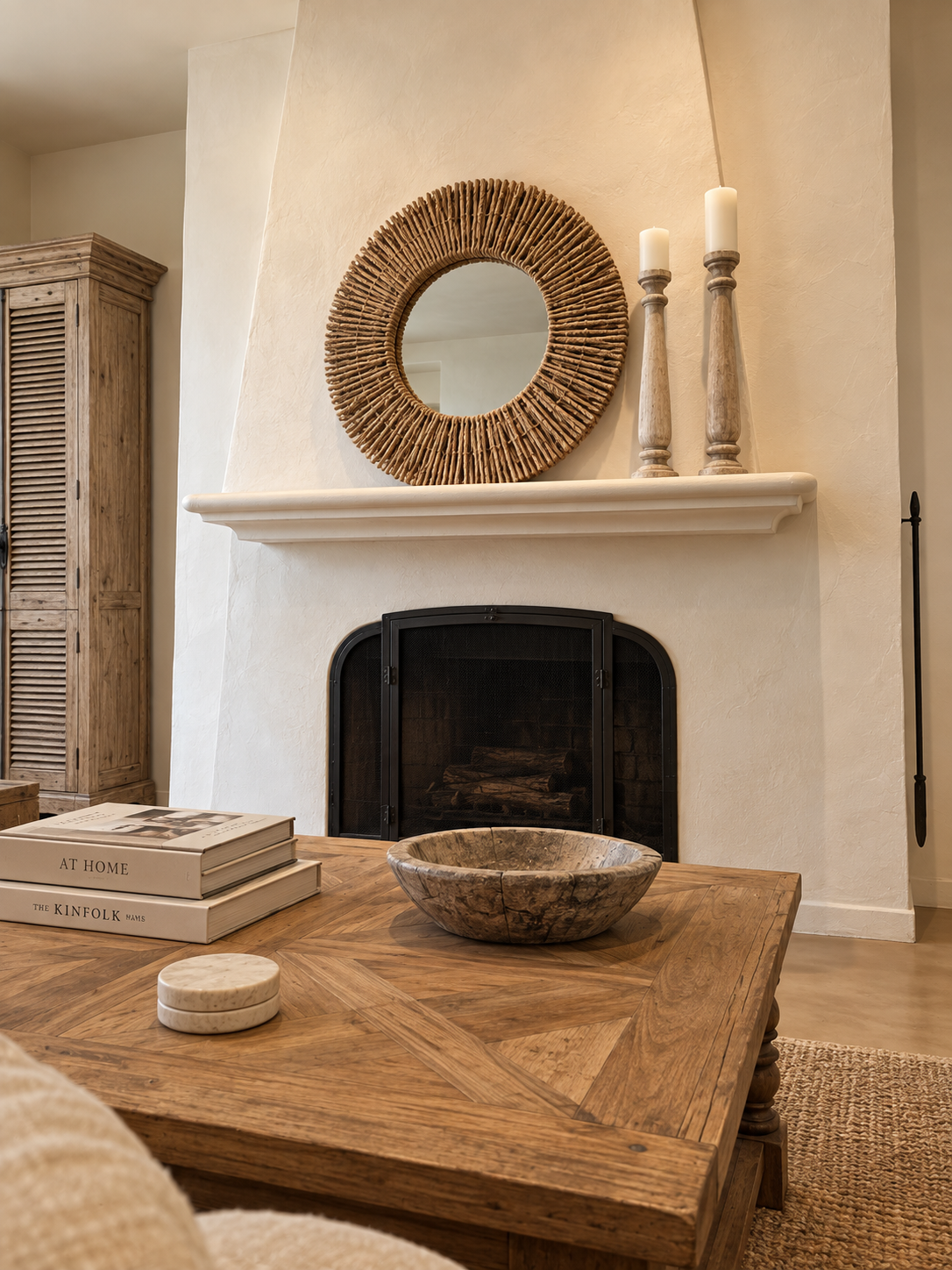 Casa Blanca plaster fireplace with a round woven mirror