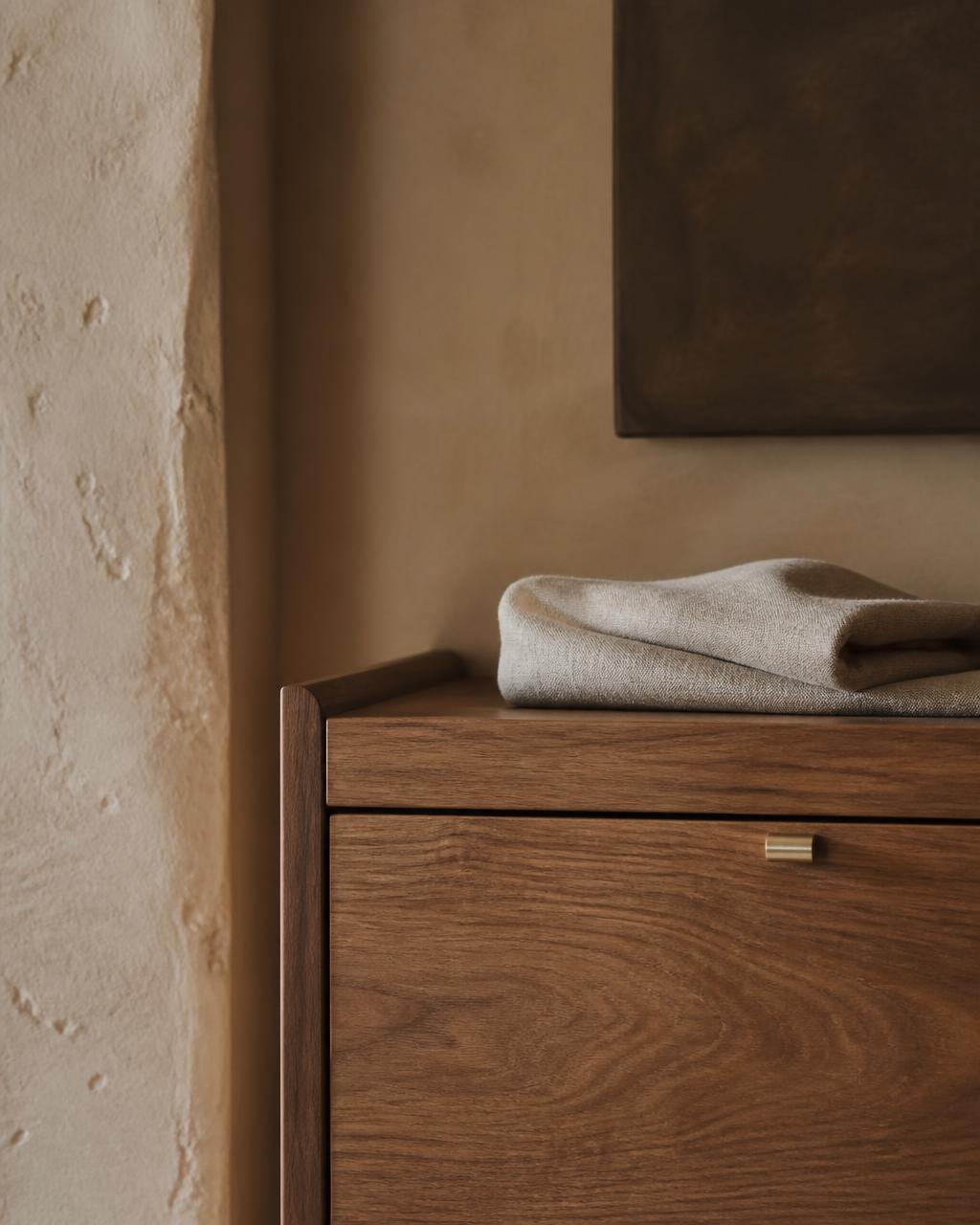 Dark walnut, aged metal and natural linen detail